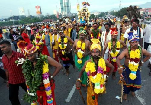 Kavadi-bearers make their way to Batu Caves during Thaipusam