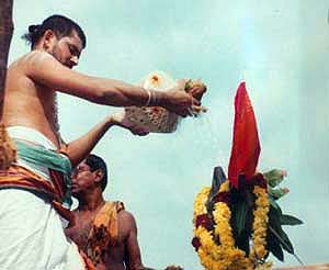 Kumbhabhishekam being performed upon one of the temples